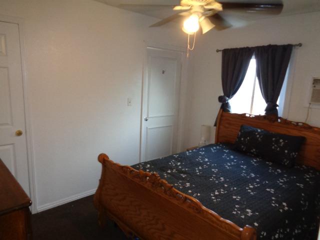 1084 Cyrier Avenue Reedley, CA 93654 - Photo 6 of 11 a bed sitting in a room next to a window