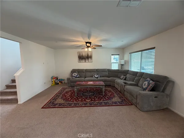 a living room with furniture and a chandelier