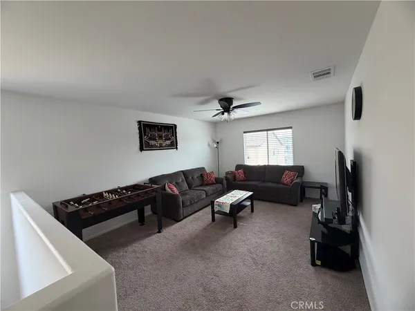a living room with furniture window and a flat screen tv