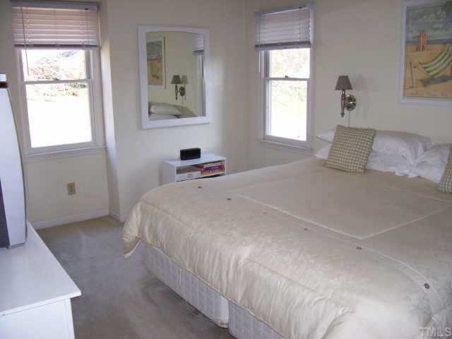 4609 Kresson Place Raleigh, NC 27616 - Photo 4 of 10 a bedroom with a bed and a window
