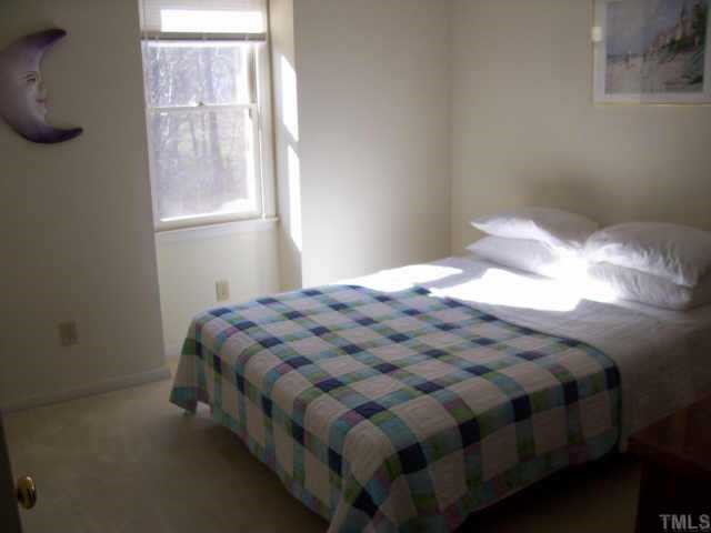 4609 Kresson Place Raleigh, NC 27616 - Photo 6 of 10 a bed sitting in a bedroom next to a window