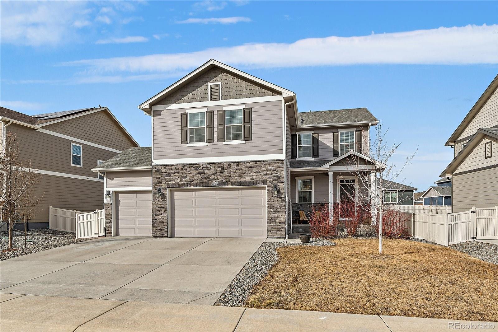 10097 Cedar Street Firestone, CO 80504 - Photo 1 of 37 a front view of a house with a yard