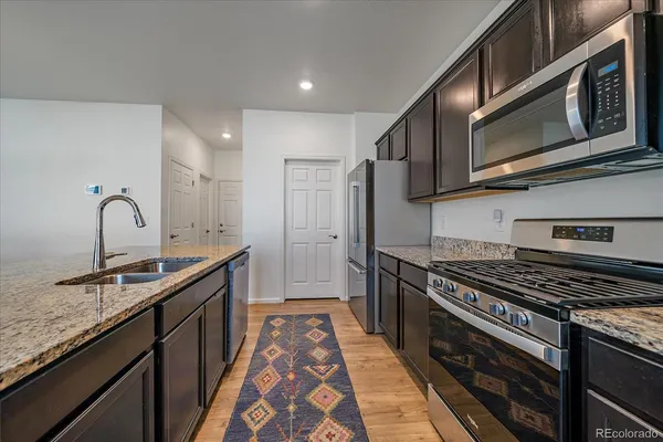 a kitchen with stainless steel appliances granite countertop a stove and a sink