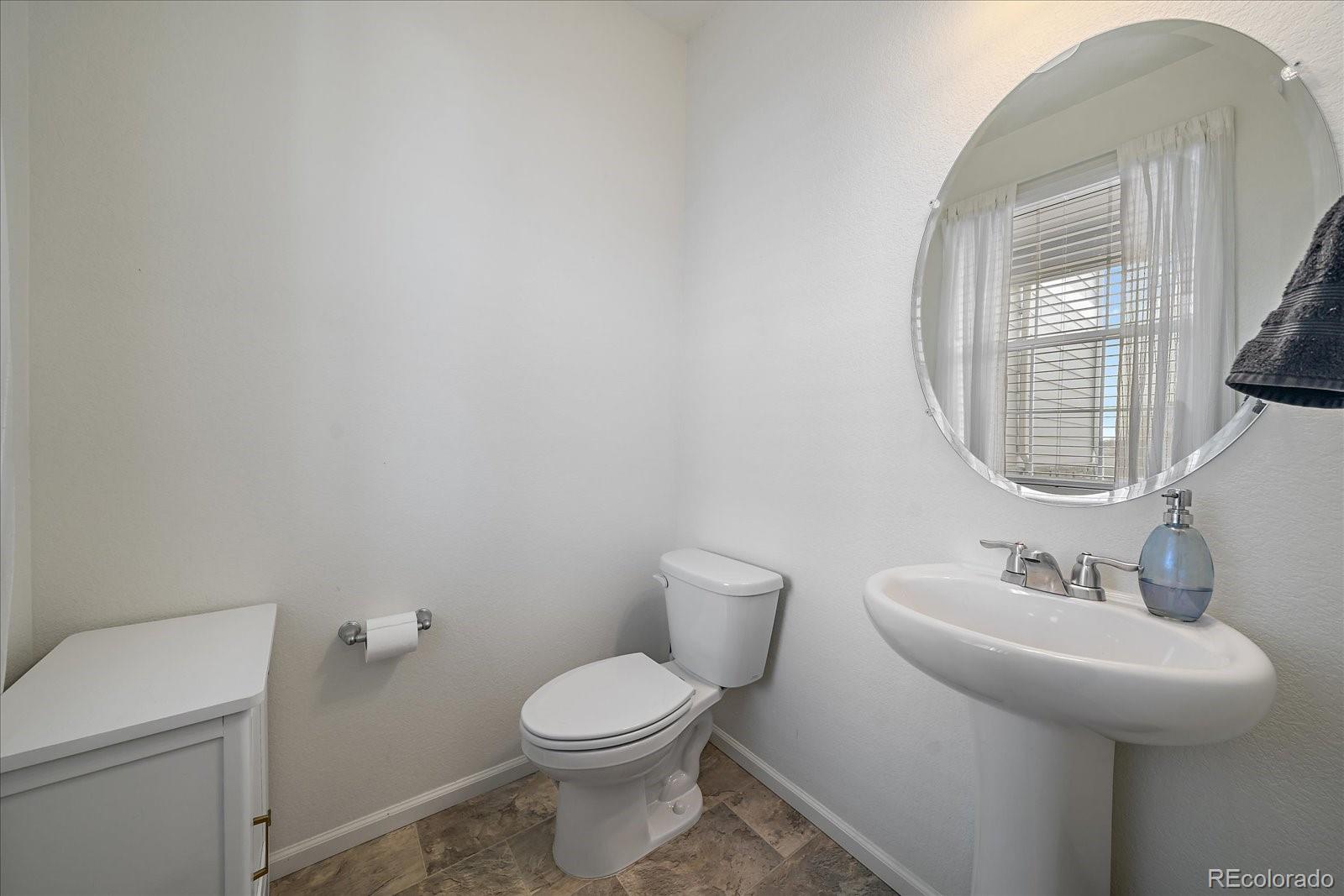10097 Cedar Street Firestone, CO 80504 - Photo 13 of 37 a bathroom with a toilet a sink and mirror