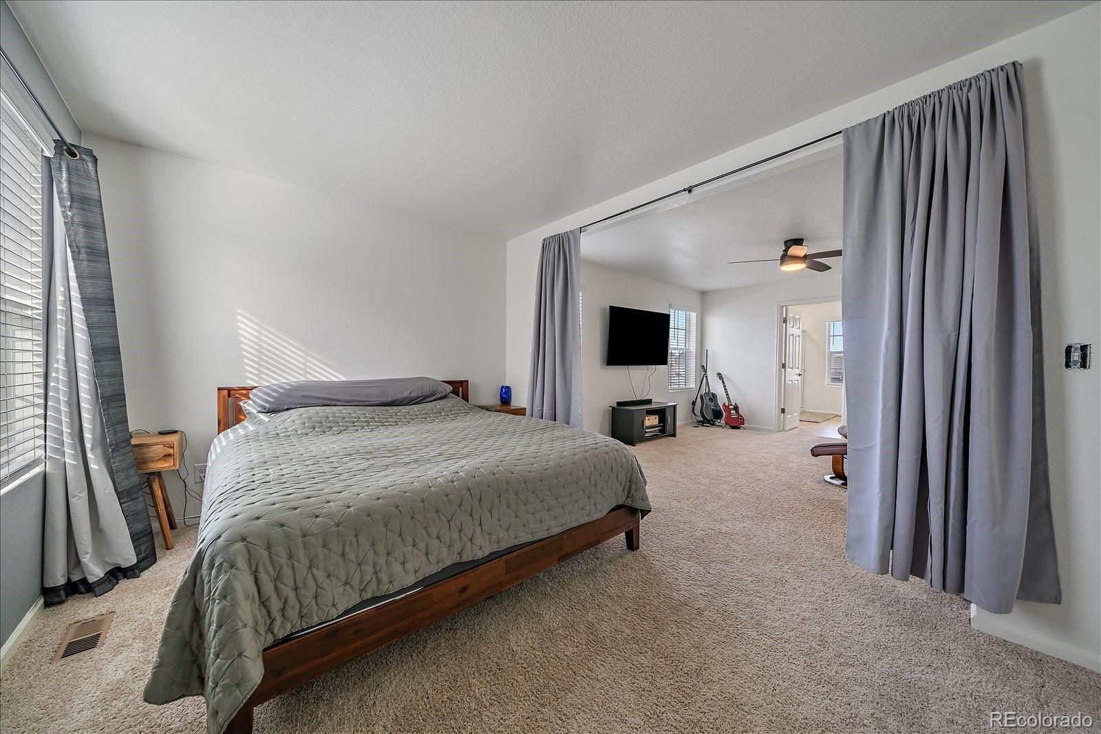 10097 Cedar Street Firestone, CO 80504 - Photo 19 of 37 a bed room with a bed and a window