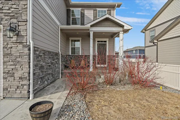 a view of a wooden house with a yard and large tree