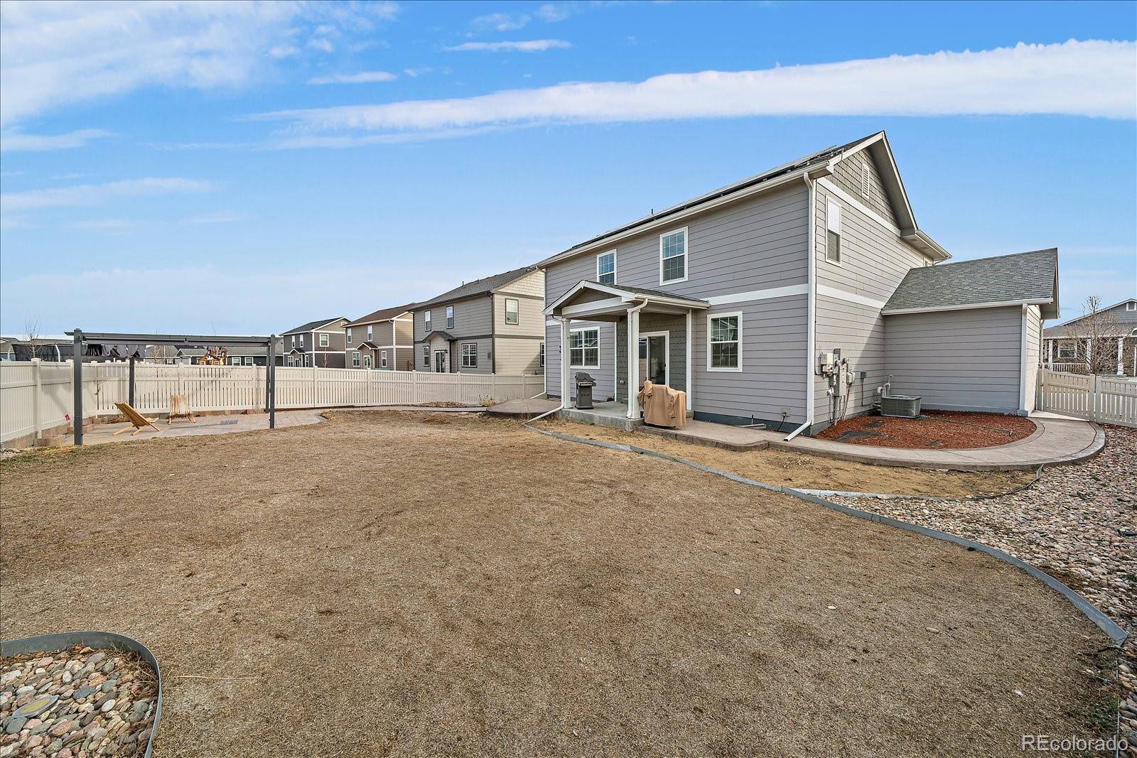 10097 Cedar Street Firestone, CO 80504 - Photo 31 of 37 a view of an house with backyard and road