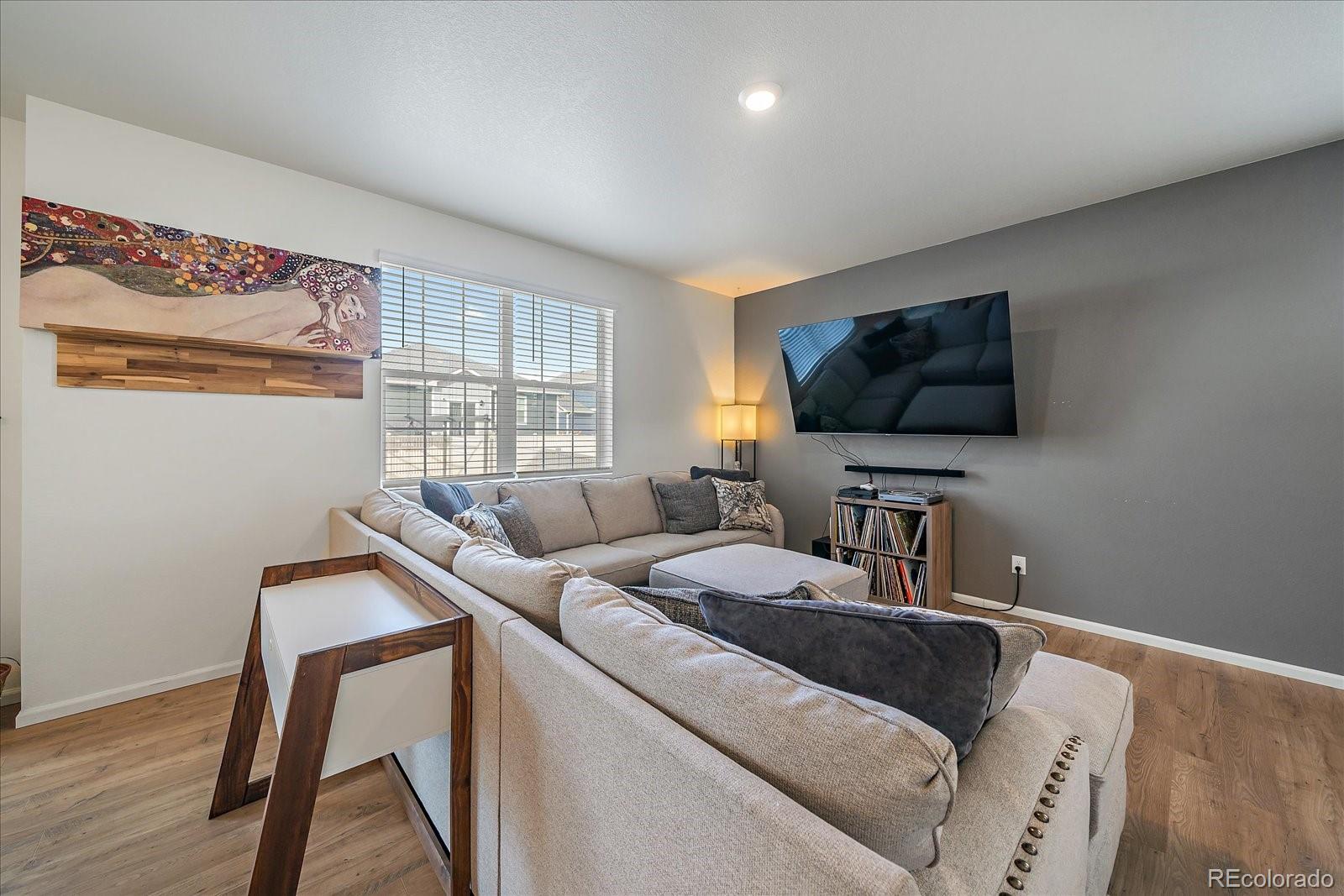 10097 Cedar Street Firestone, CO 80504 - Photo 6 of 37 a living room with furniture and a flat screen tv