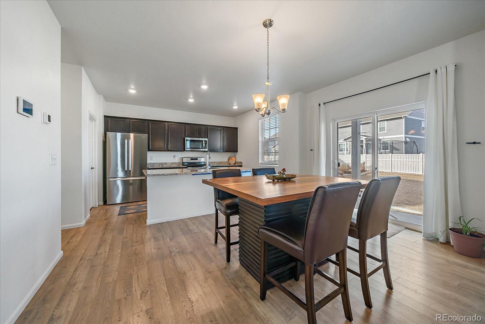 10097 Cedar Street Firestone, CO 80504 - Photo 8 of 37 a dining area with a table chairs and entryway