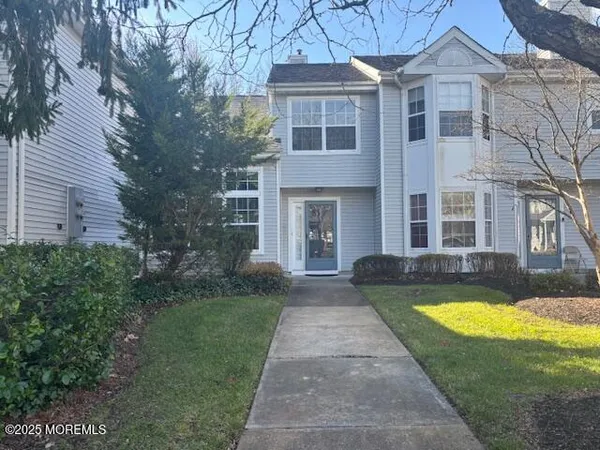 a view of a brick house with a swimming pool and a yard