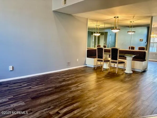 a room with wooden floor and furniture