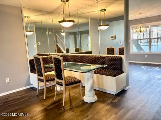 a living room with a table chairs and wooden floor