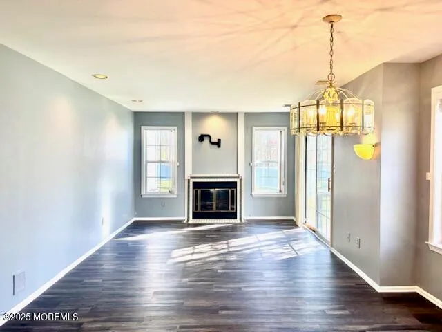 a view of a livingroom with a fireplace and window