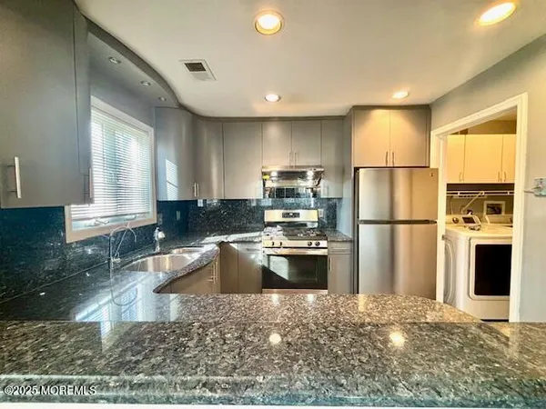 a kitchen with refrigerator and microwave