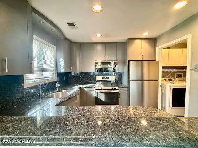a kitchen with refrigerator and microwave