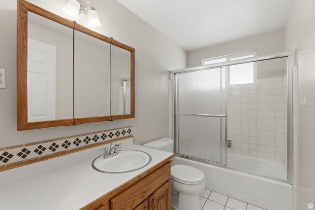 148 Tennyson Avenue Sandy, UT 84070 - Photo 18 of 55 Bathroom vanity with an integrated sink, polished chrome faucet, and wood-finish cabinetry