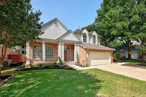 a front view of a house with a yard and porch