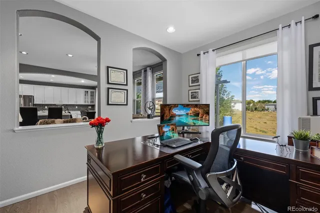 a kitchen with stainless steel appliances granite countertop a stove top oven a sink a stove a dining table and chairs