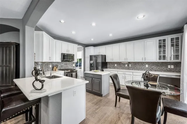 a kitchen with a sink a stove and cabinets