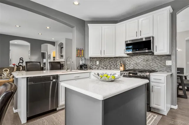 a kitchen with a table chairs and microwave