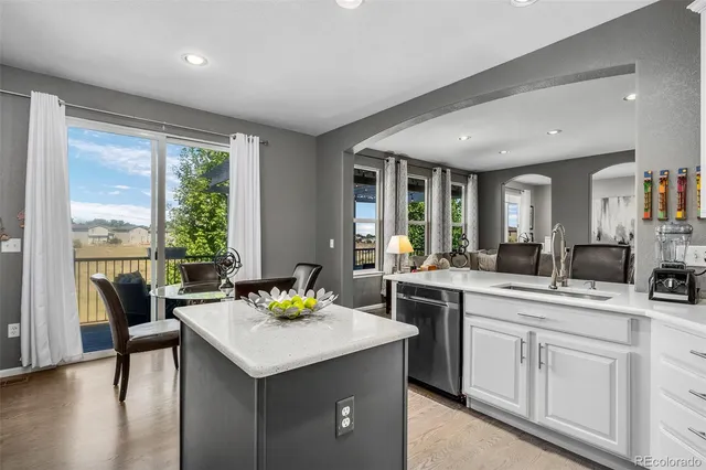 a view of a dining room with furniture a chandelier and wooden floor