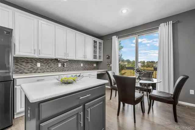 a view of a dining room with furniture wooden floor and chandelier