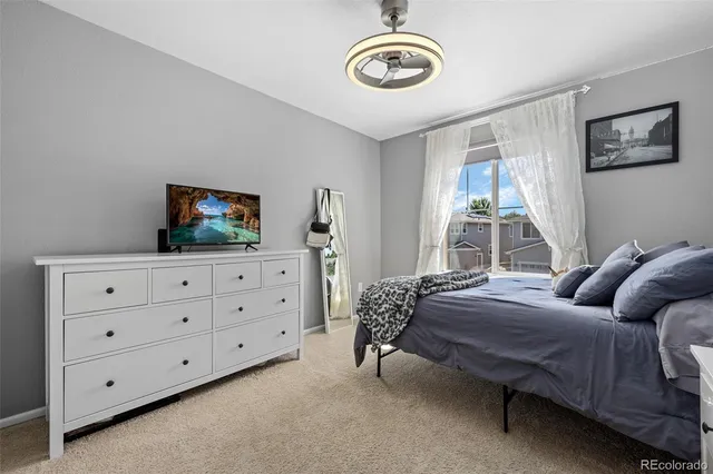 a bedroom that has a bed and a table in it