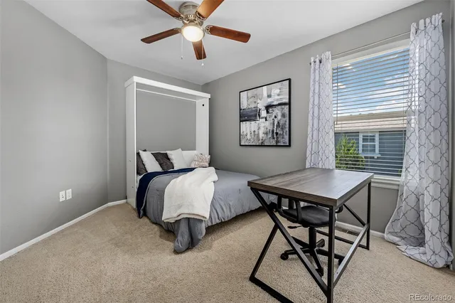 a bedroom with bed and a flat screen tv