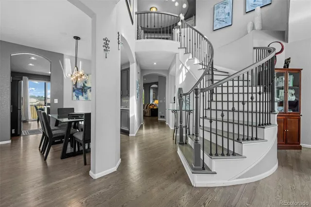a view of entryway and hall with wooden floor