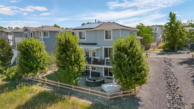 an aerial view of ocean and residential houses with outdoor space