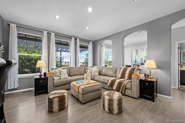 a living room with furniture and large windows