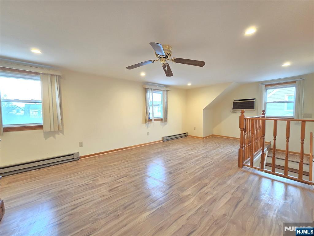 701 4th Street Secaucus, NJ 07094 - Photo 16 of 21 a view of an empty room with wooden floor and a window