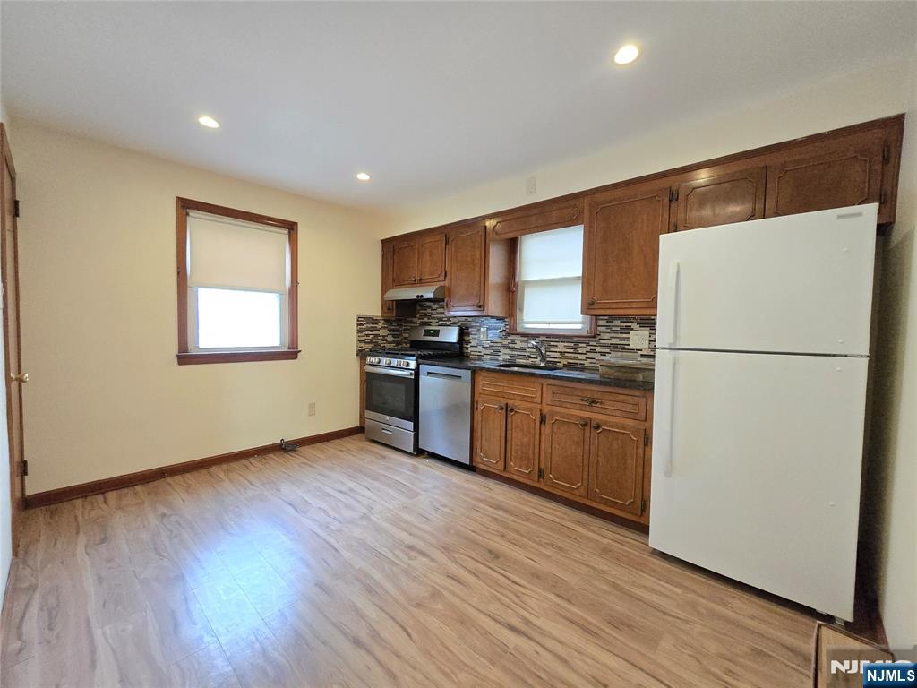 701 4th Street Secaucus, NJ 07094 - Photo 6 of 21 a kitchen with a refrigerator and a stove top oven