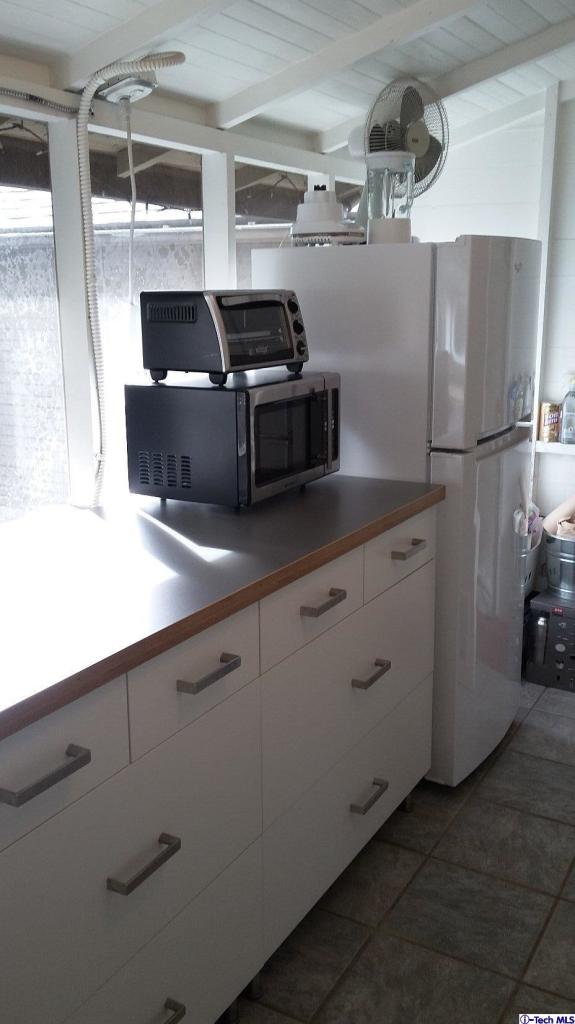 970 Cornell Road Pasadena, CA 91106 - Photo 10 of 14 a kitchen with cabinets and stainless steel appliances