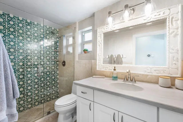 a bathroom with a sink toilet and shower