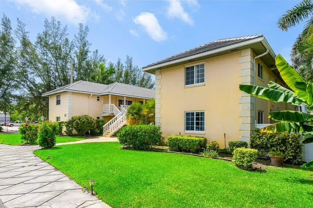 a aerial view of a house with yard and green space