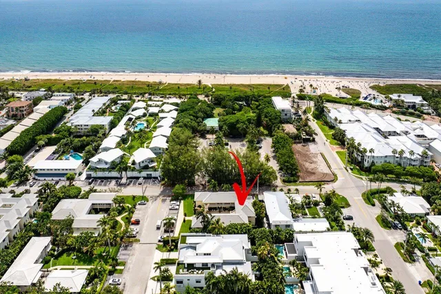 an aerial view of multiple houses with yard