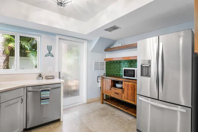 a kitchen with stainless steel appliances a refrigerator and a sink