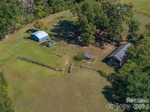 an aerial view of a house with a yard basket ball court and outdoor seating