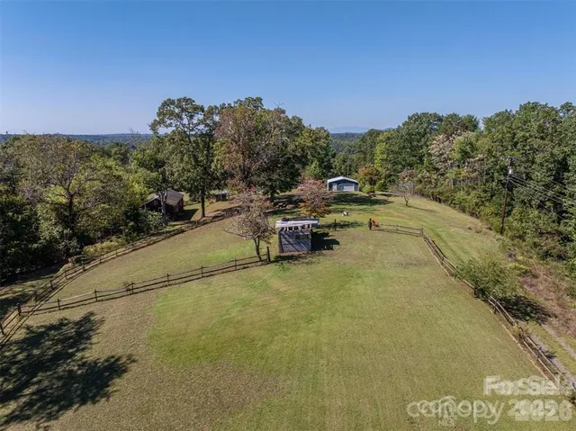 a view of a swimming pool with a yard and sitting area