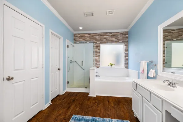 a bathroom with a sink a large mirror and shower