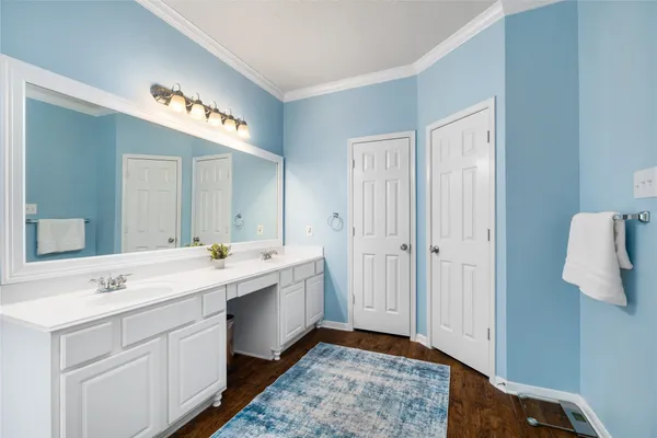 a spacious bathroom with a double vanity sink and mirror
