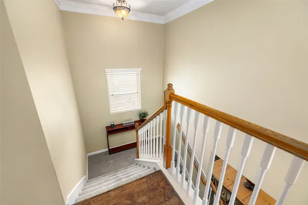 a view of a hallway with wooden cabinets