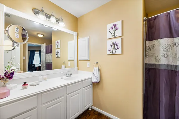 a view of a kitchen with sink and wooden floor