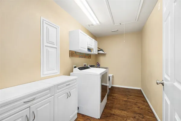 a dining room with furniture and a large window