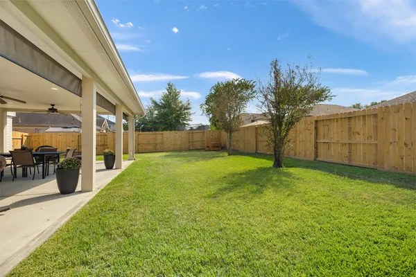 a view of a house with a yard and sitting area