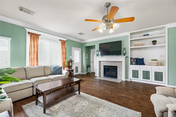 a living room with furniture a flat screen tv and a fireplace