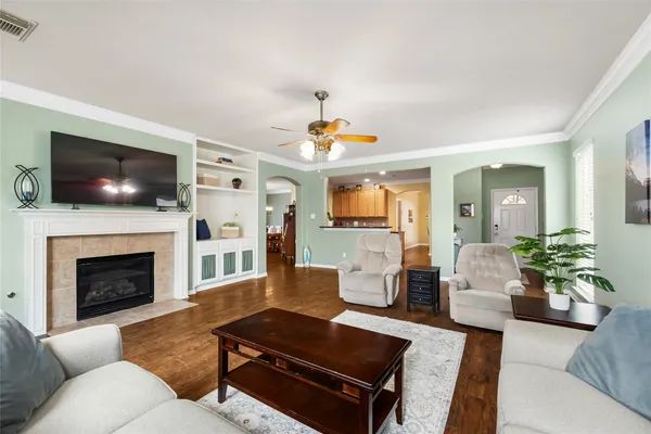 a living room with furniture a flat screen tv and a fireplace