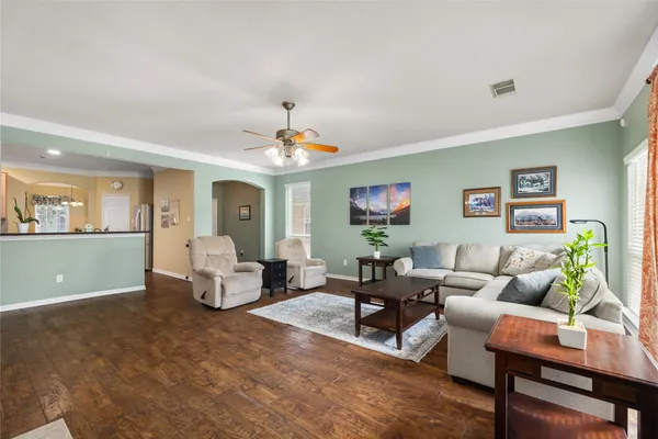 a living room with furniture and a chandelier