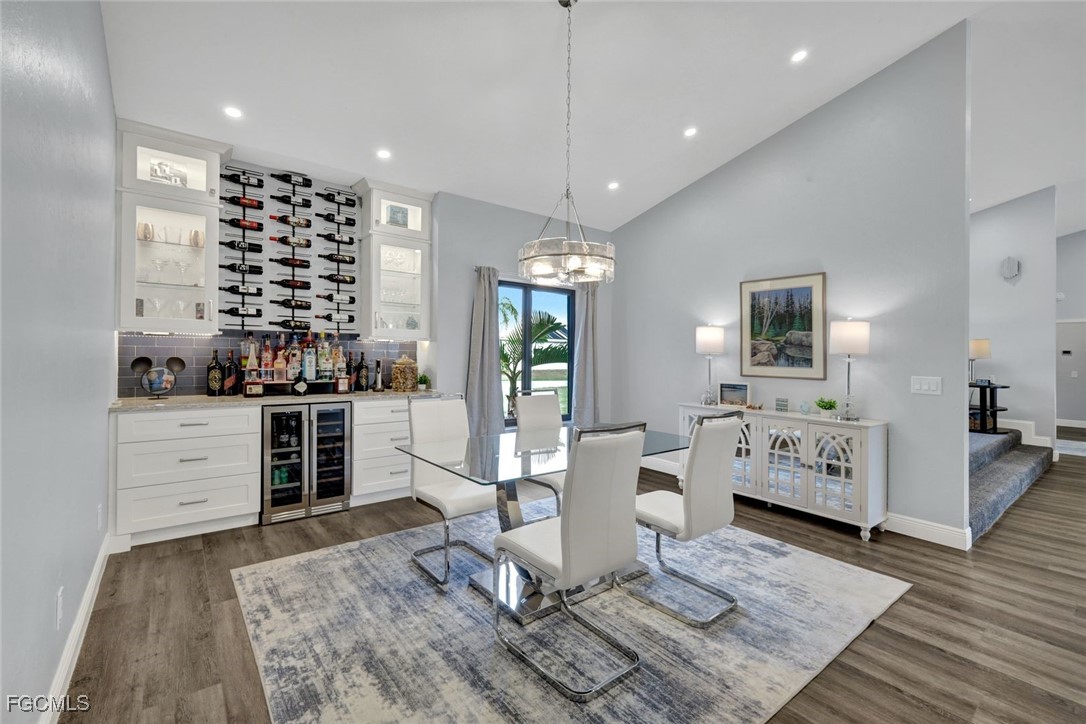 5346 Southwest 10th Avenue Cape Coral, FL 33914 - Photo 12 of 50 a living room with furniture a flat screen tv and kitchen view